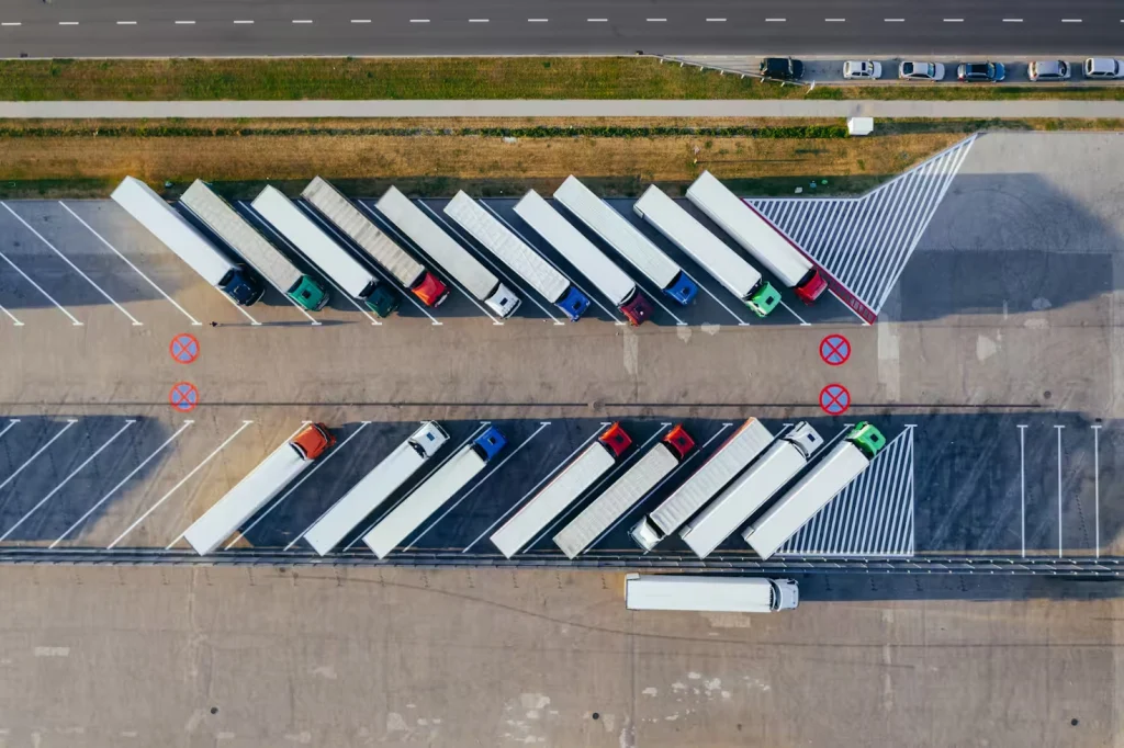 Reduce Microplastic Pollution in Logistics -Unsplash Areal Image of Trucks Parked Diagonally