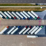 Reduce Microplastic Pollution in Logistics -Unsplash Areal Image of Trucks Parked Diagonally