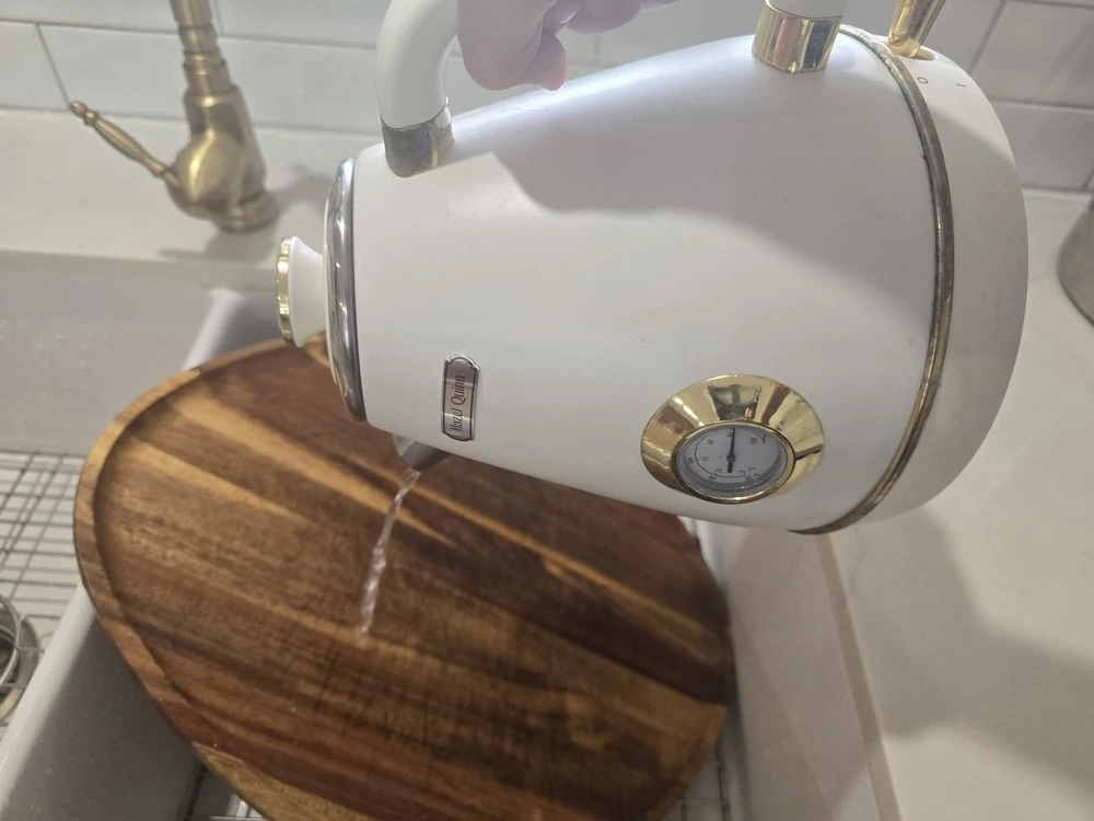 I'm Plastic Free pouring boiling water over a wooden cutting board